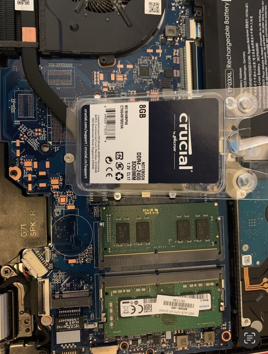 A laptop with the base removed, showing an SSD and memory modules